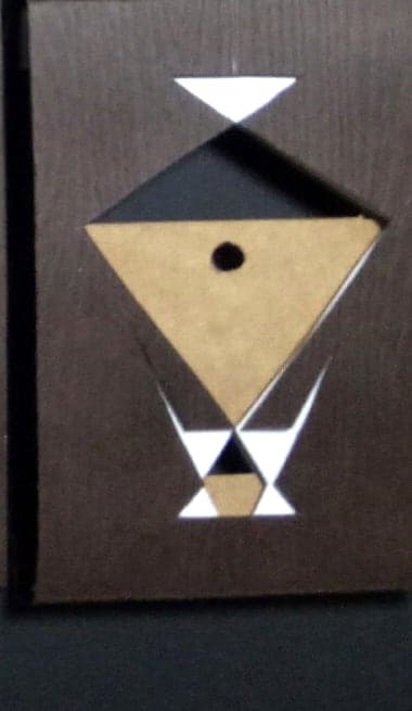 Aquarius chocolate box: geometric paper-cut sign emblem on dark wood-textured paper
