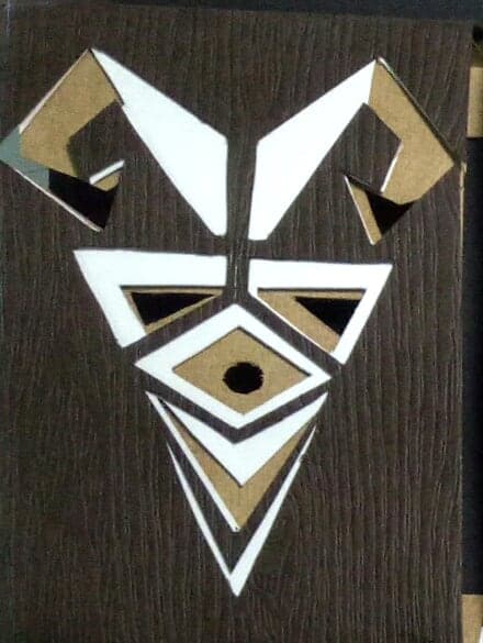 Aries chocolate box: geometric paper-cut sign emblem on dark wood-textured paper