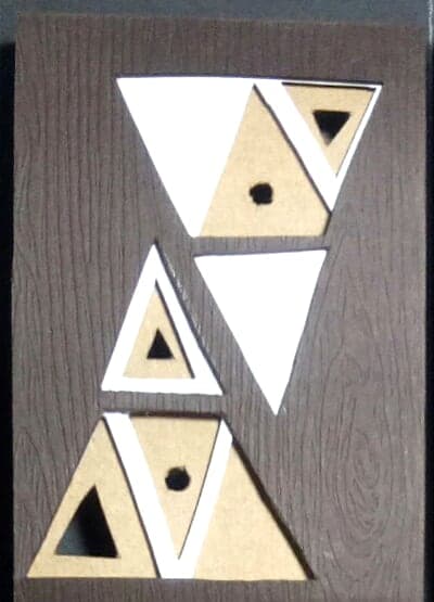 Gemini chocolate box: geometric paper-cut sign emblem on dark wood-textured paper