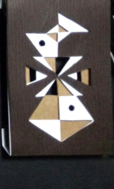 Pisces chocolate box: geometric paper-cut sign emblem on dark wood-textured paper