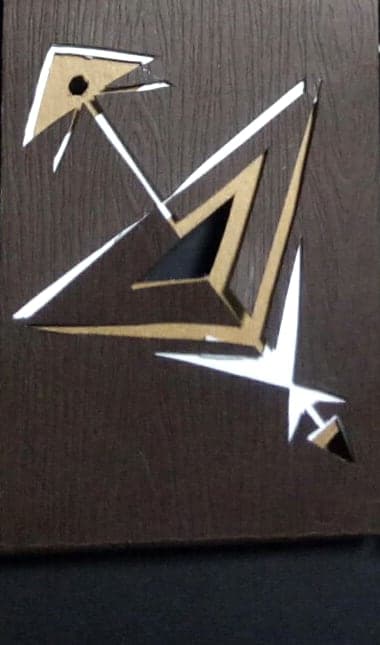 Sagittarius chocolate box: geometric paper-cut sign emblem on dark wood-textured paper
