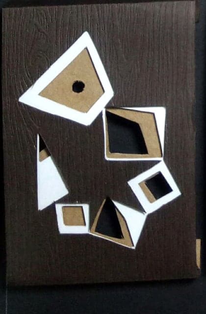 Scorpio chocolate box: geometric paper-cut sign emblem on dark wood-textured paper