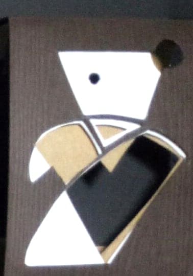 Virgo chocolate box: geometric paper-cut sign emblem on dark wood-textured paper